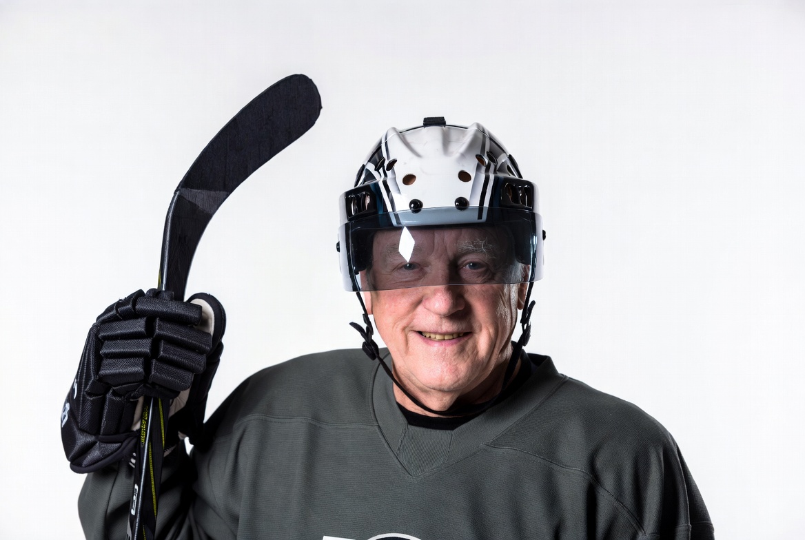 Senior man holding hockey stick Senior man holding hockey stick