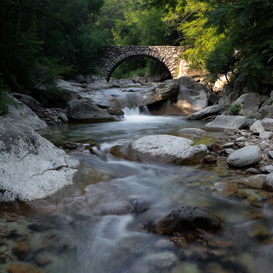 Stone Arch Bridge over Forest Stream Stone Arch Bridge over Forest Stream
