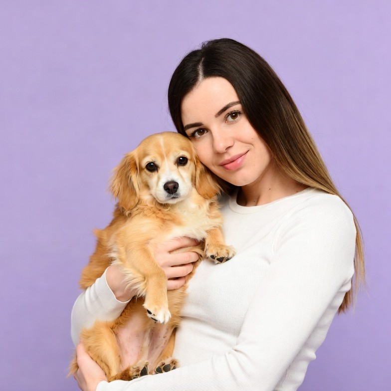 Woman holding cute small dog Woman holding cute small dog