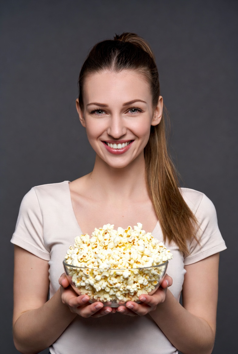 Woman holding bowl of popcorn Woman holding bowl of popcorn