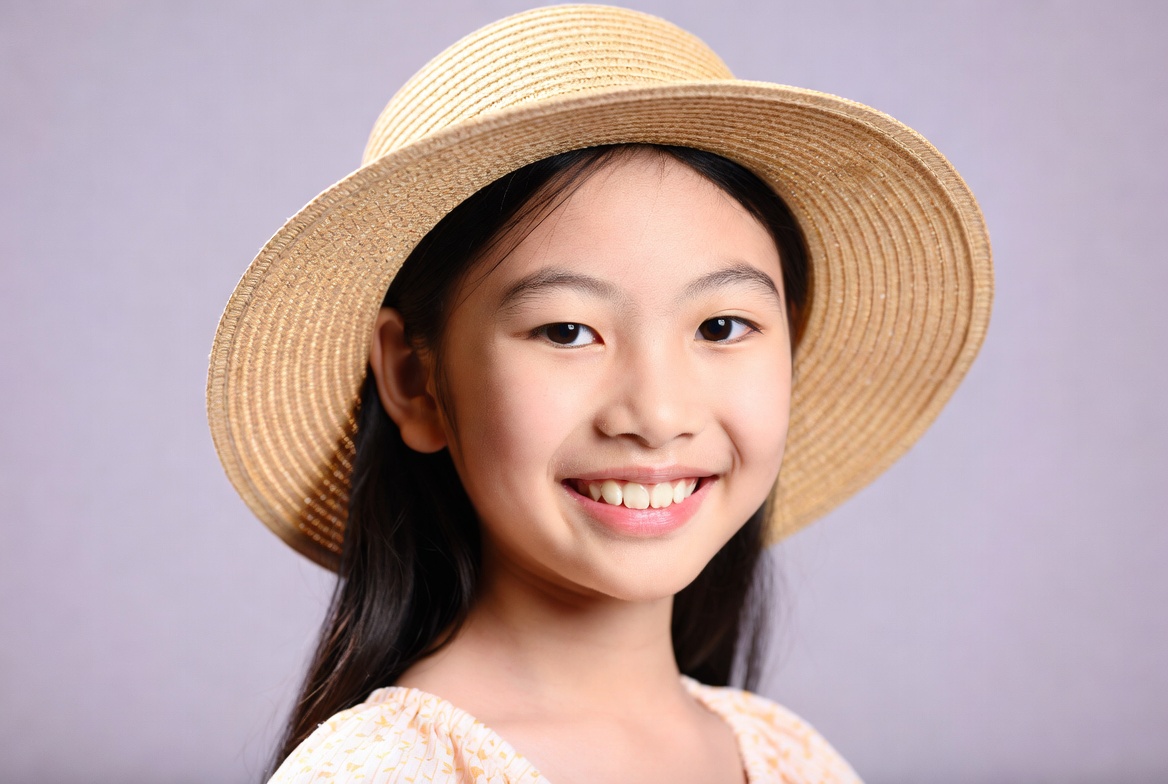 Asian girl smiling in straw hat Asian girl smiling in straw hat