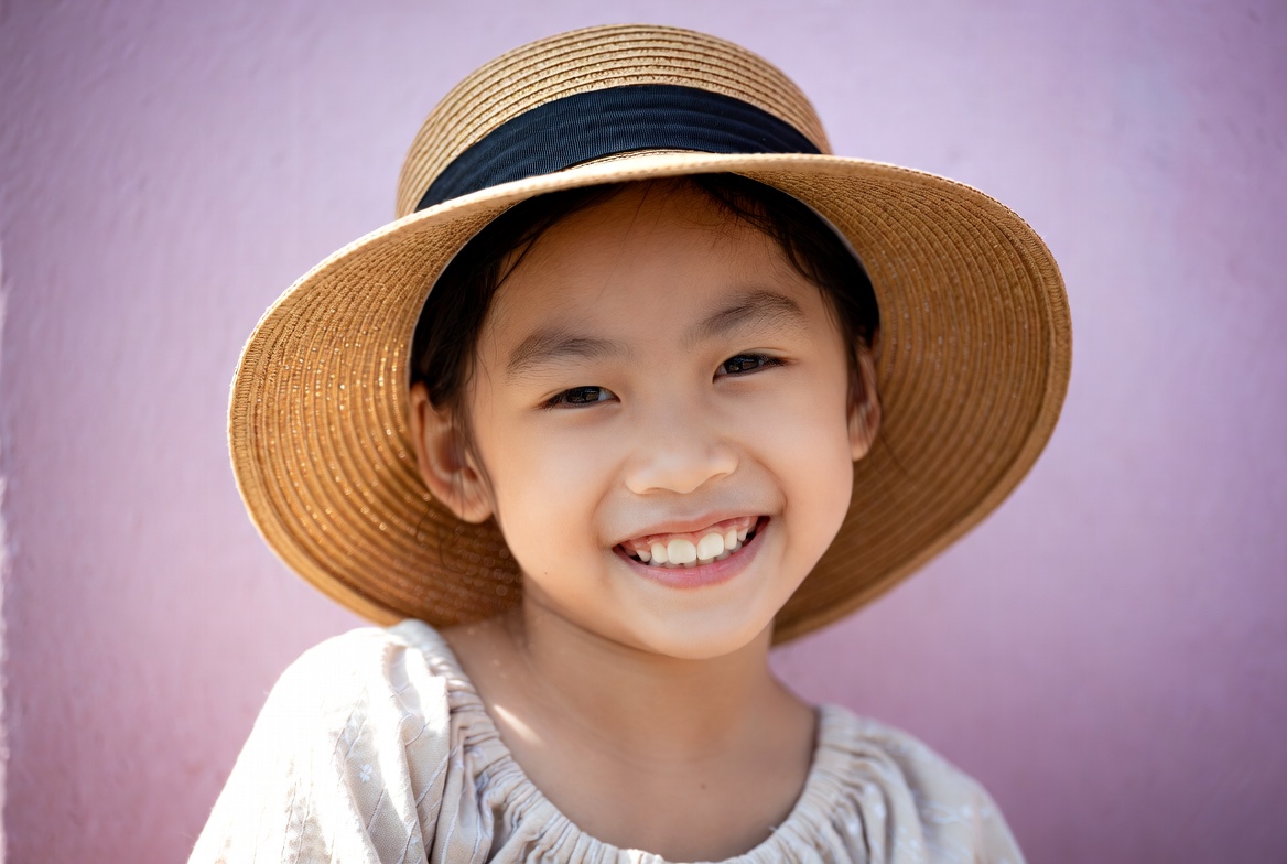 Asian girl smiling in straw hat Asian girl smiling in straw hat