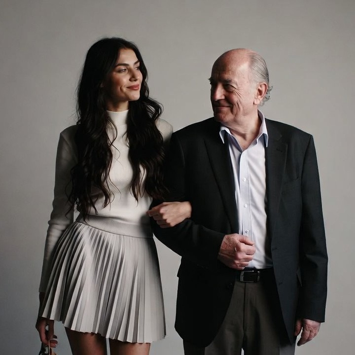 Young woman and older man embracing Young woman and older man embracing