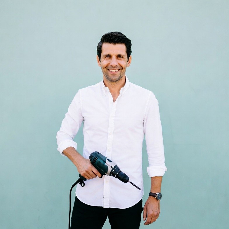 Man holding drill on green background Man holding drill on green background