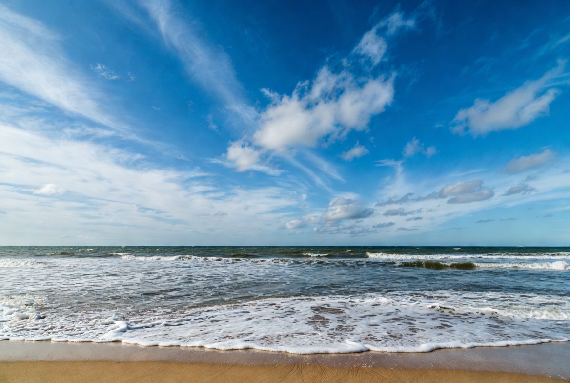 Ocean waves crashing on sandy beach Ocean waves crashing on sandy beach