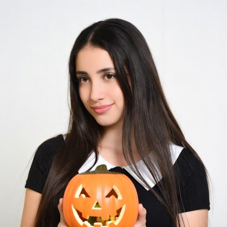 Woman holding jack-o-lantern pumpkin Woman holding jack-o-lantern pumpkin