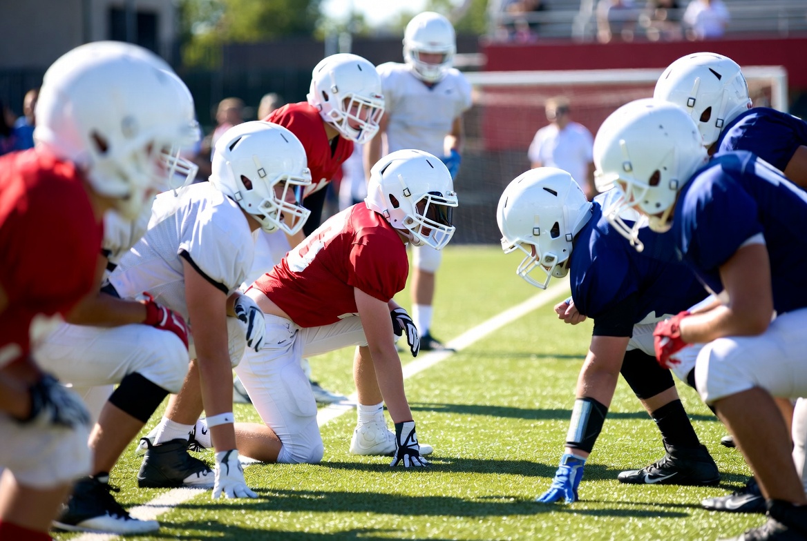 Football players in huddle on field Football players in huddle on field