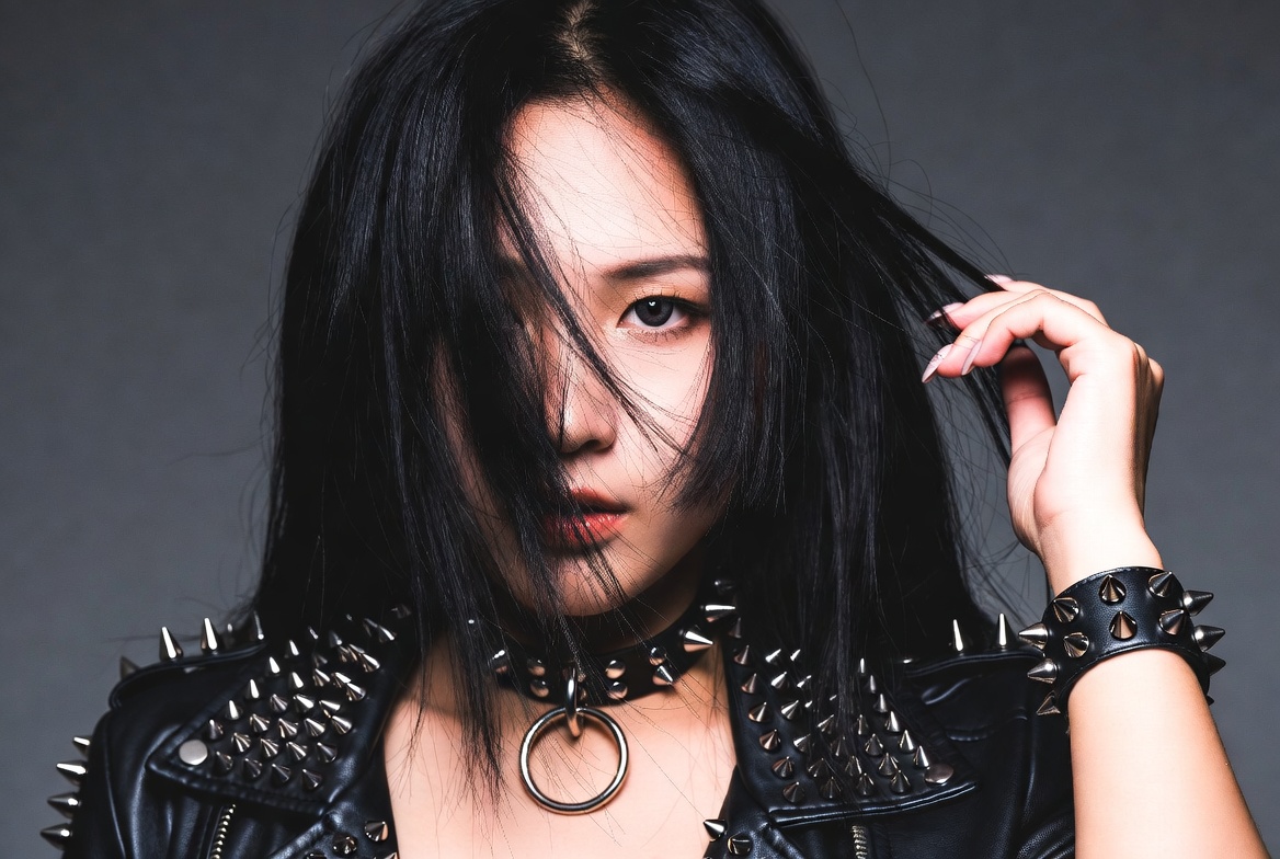 Asian woman in spiked leather jacket Asian woman in spiked leather jacket