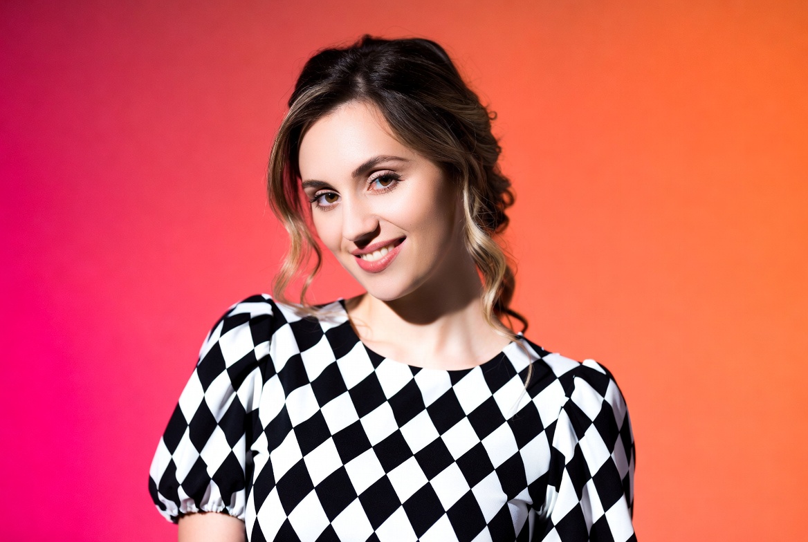 Woman in checkered dress on orange background Woman in checkered dress on orange background