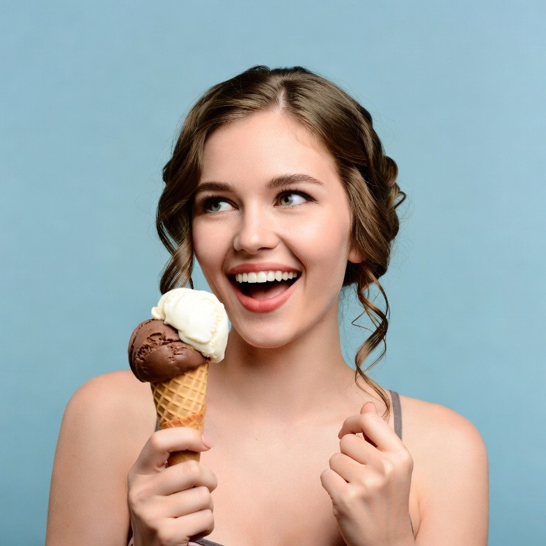 Young woman eating ice cream cone Young woman eating ice cream cone