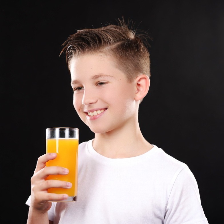 Boy drinking orange juice Boy drinking orange juice