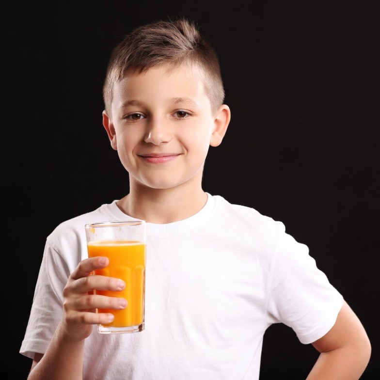 Boy holding glass of orange juice Boy holding glass of orange juice