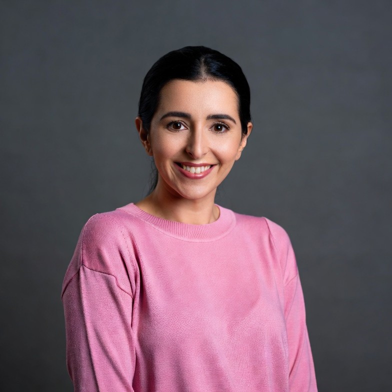 Smiling Middle Eastern woman in pink sweater Smiling Middle Eastern woman in pink sweater