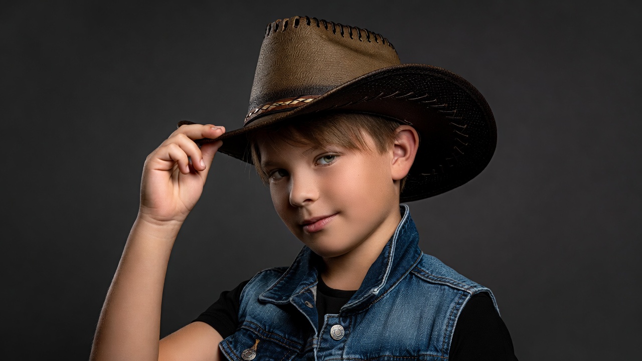 Boy tipping cowboy hat Boy tipping cowboy hat