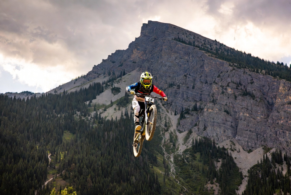 Mountain biker jumping over rocky cliffs Mountain biker jumping over rocky cliffs