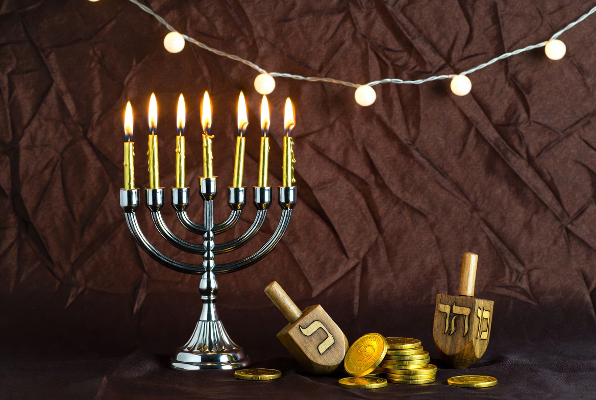 Lit Hanukkah Menorah with Dreidels and Coins Lit Hanukkah Menorah with Dreidels and Coins