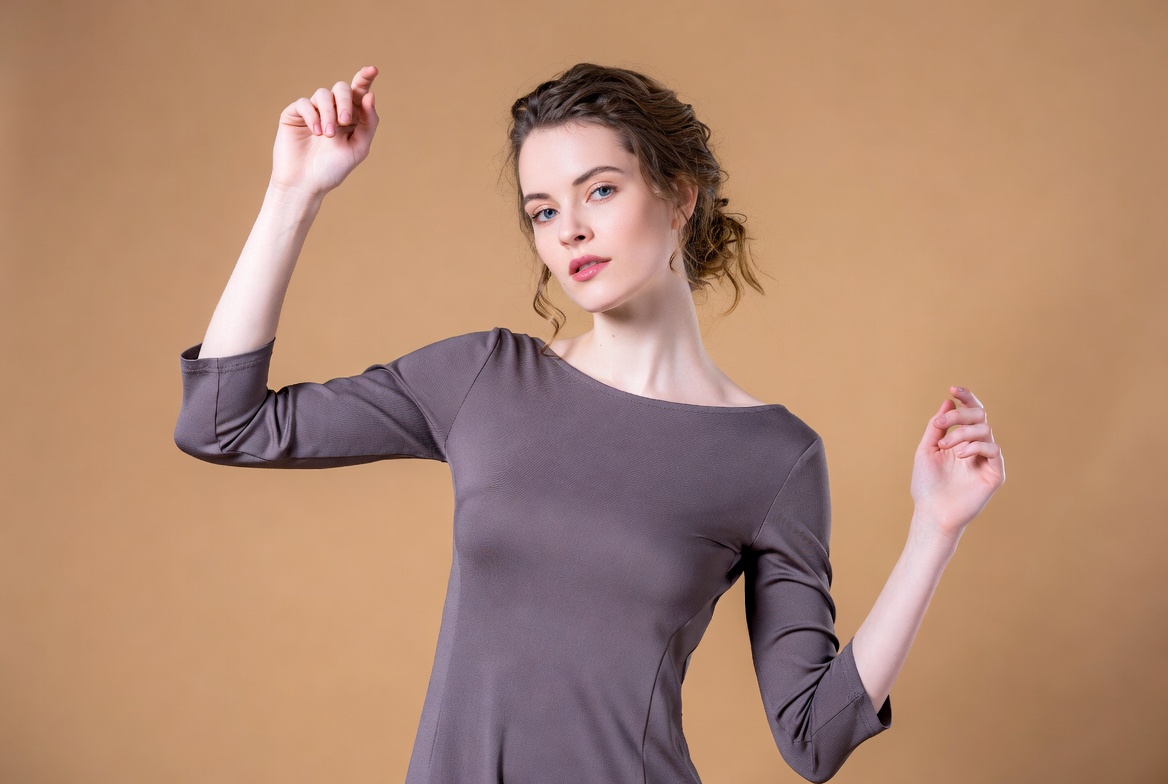 Woman dancing in gray dress Woman dancing in gray dress