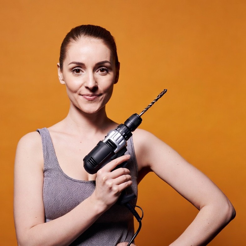 Woman holding power drill Woman holding power drill