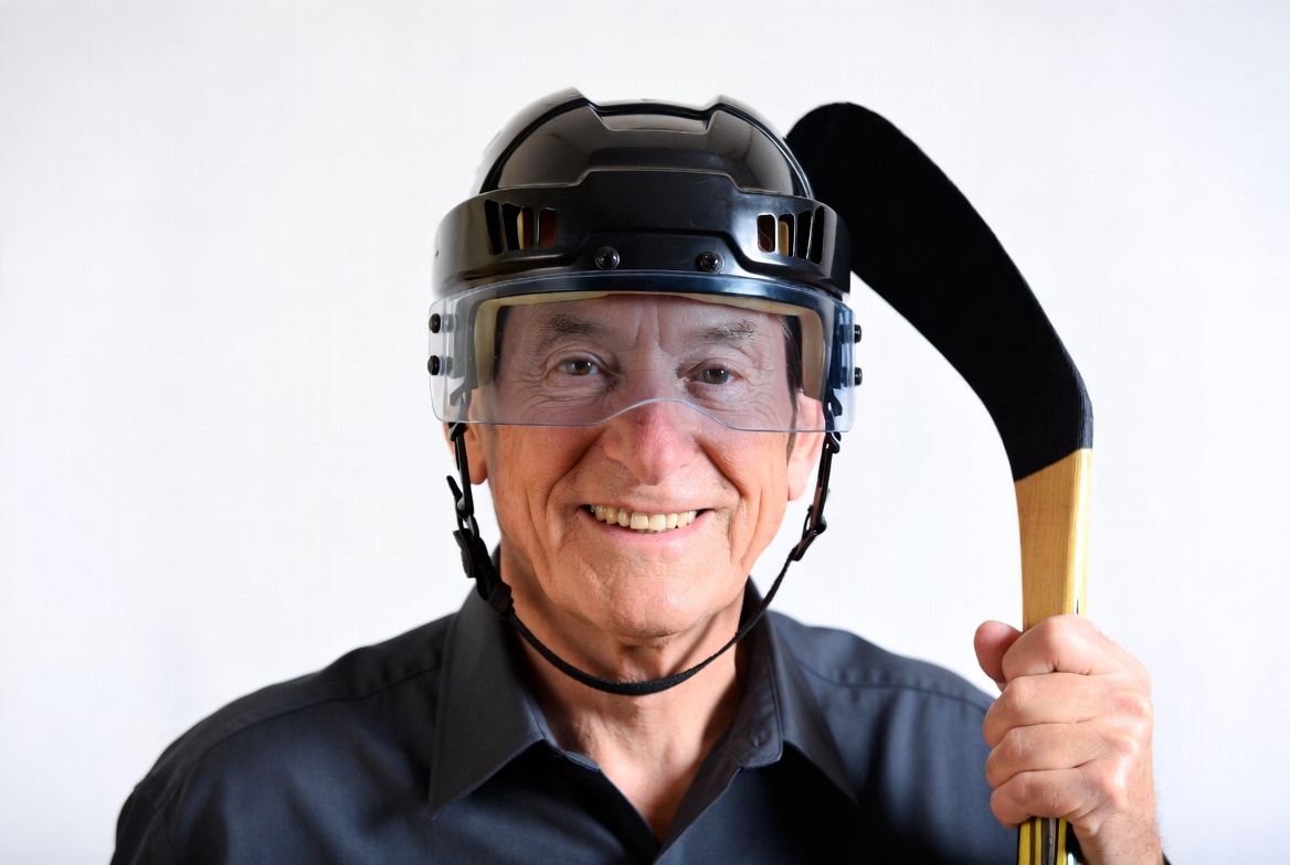 Elderly man with hockey helmet and stick Elderly man with hockey helmet and stick