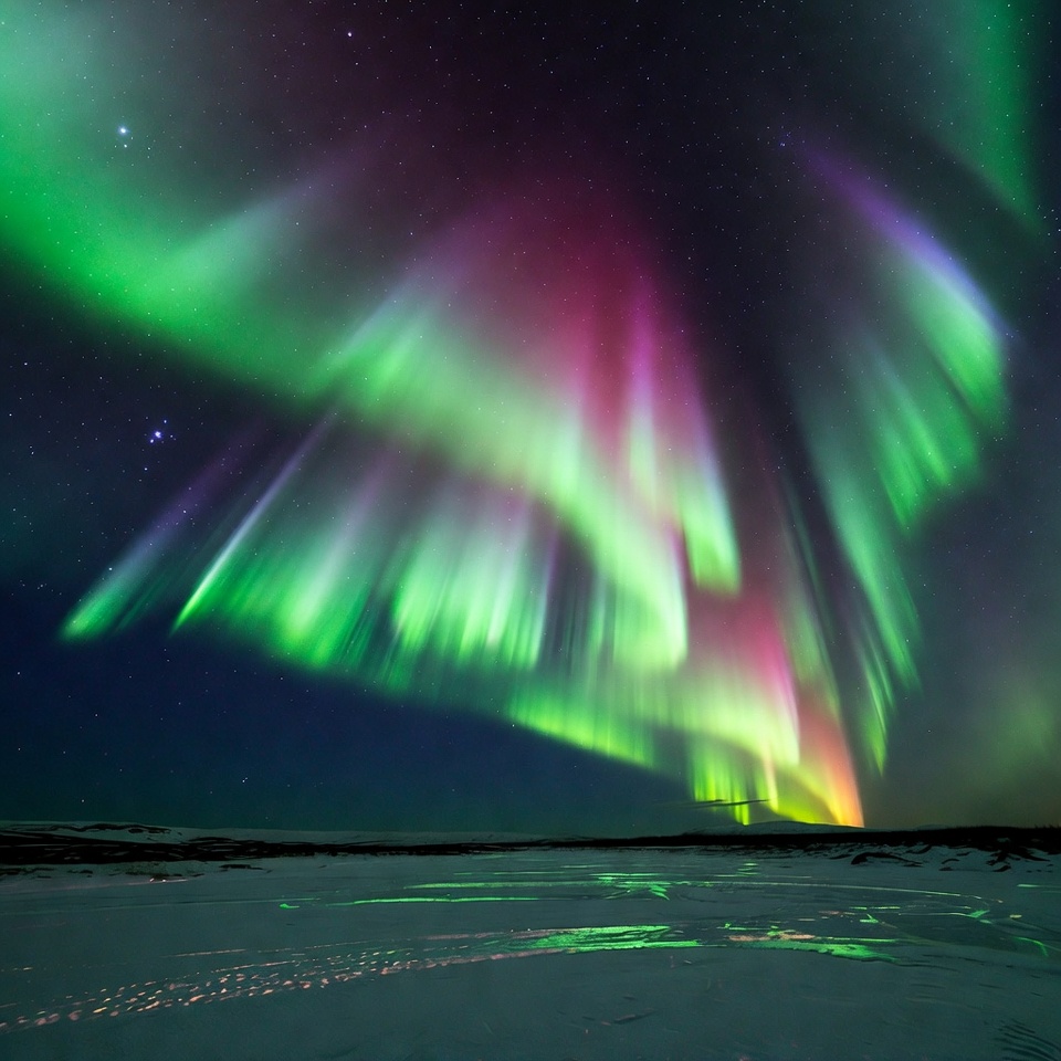 Vibrant Northern Lights over Snowy Landscape Vibrant Northern Lights over Snowy Landscape