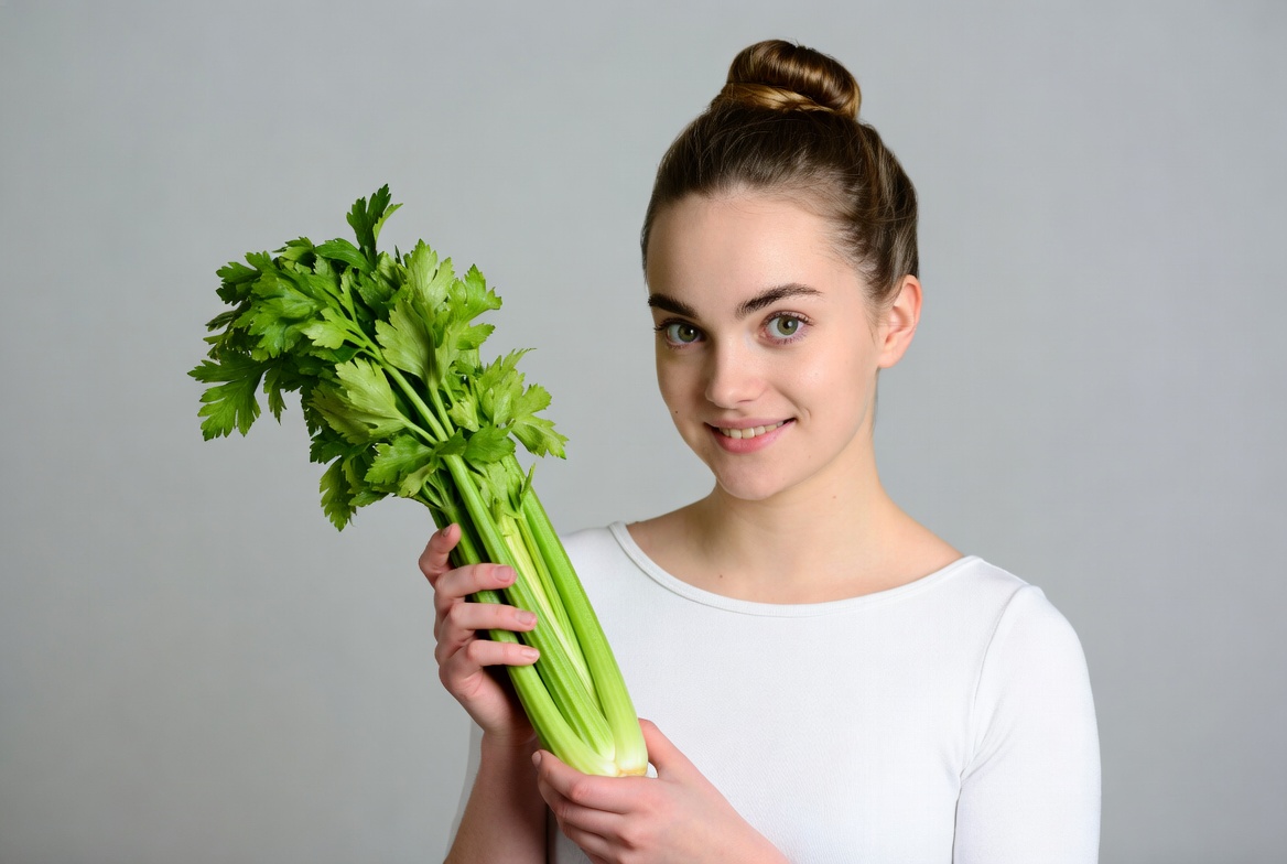 Woman holding fresh celery bunch Woman holding fresh celery bunch