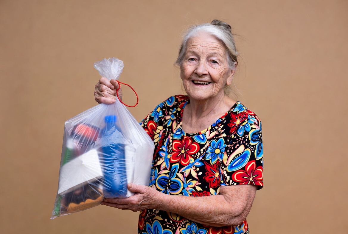 Elderly woman holding clear shopping bag Elderly woman holding clear shopping bag