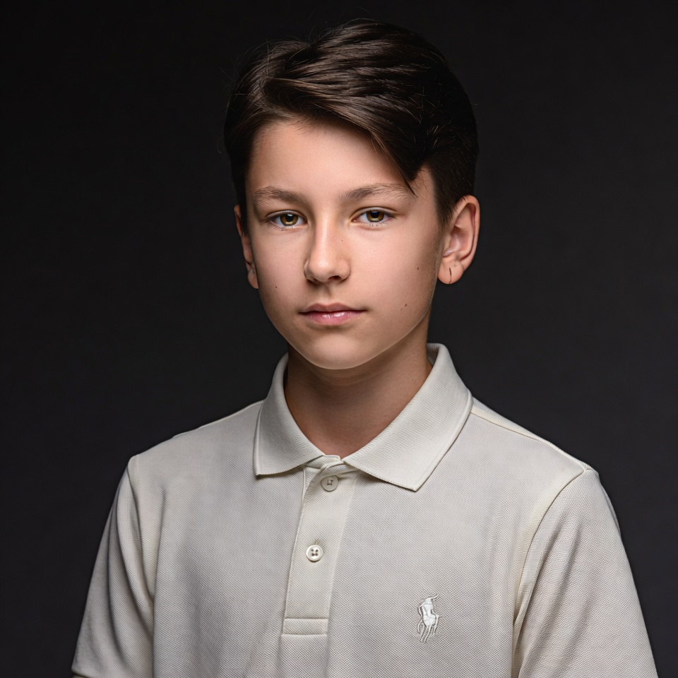 Young boy in white polo shirt Young boy in white polo shirt