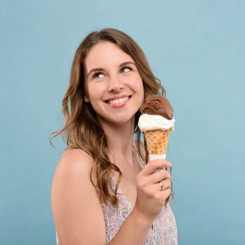 Woman holding vanilla chocolate ice cream cone Woman holding vanilla chocolate ice cream cone