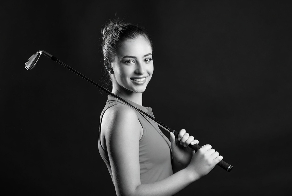 Woman holding golf club Woman holding golf club