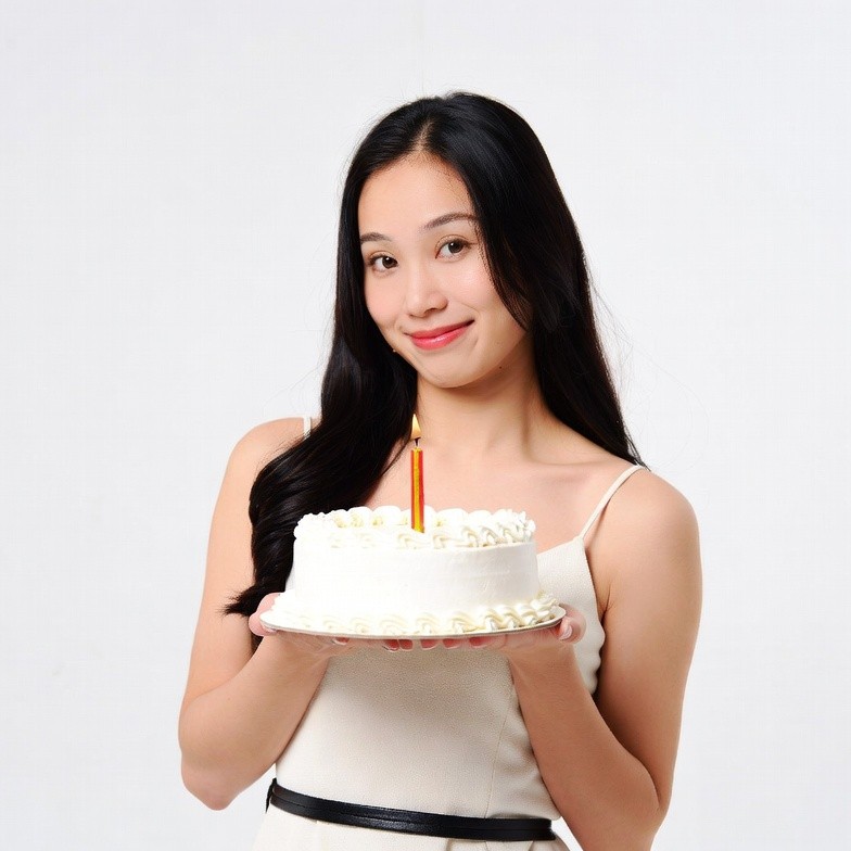 Asian woman holding birthday cake Asian woman holding birthday cake