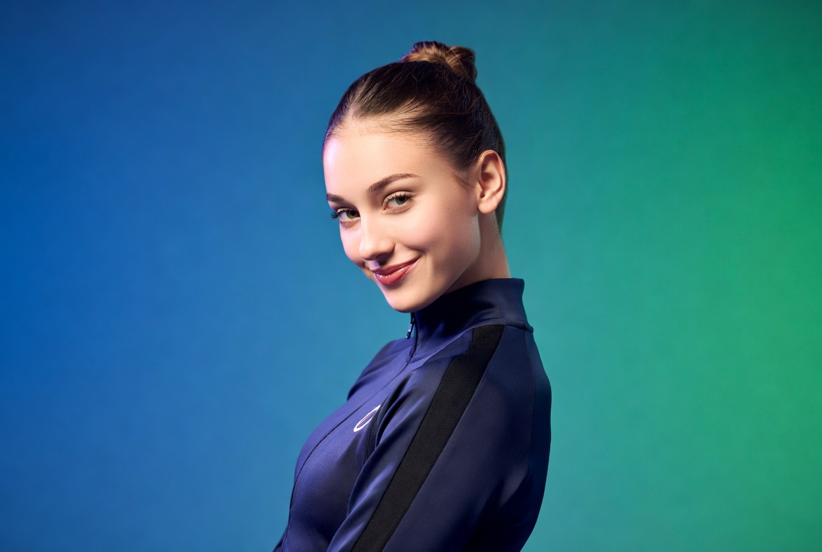 Smiling woman in navy Asics tracksuit Smiling woman in navy Asics tracksuit