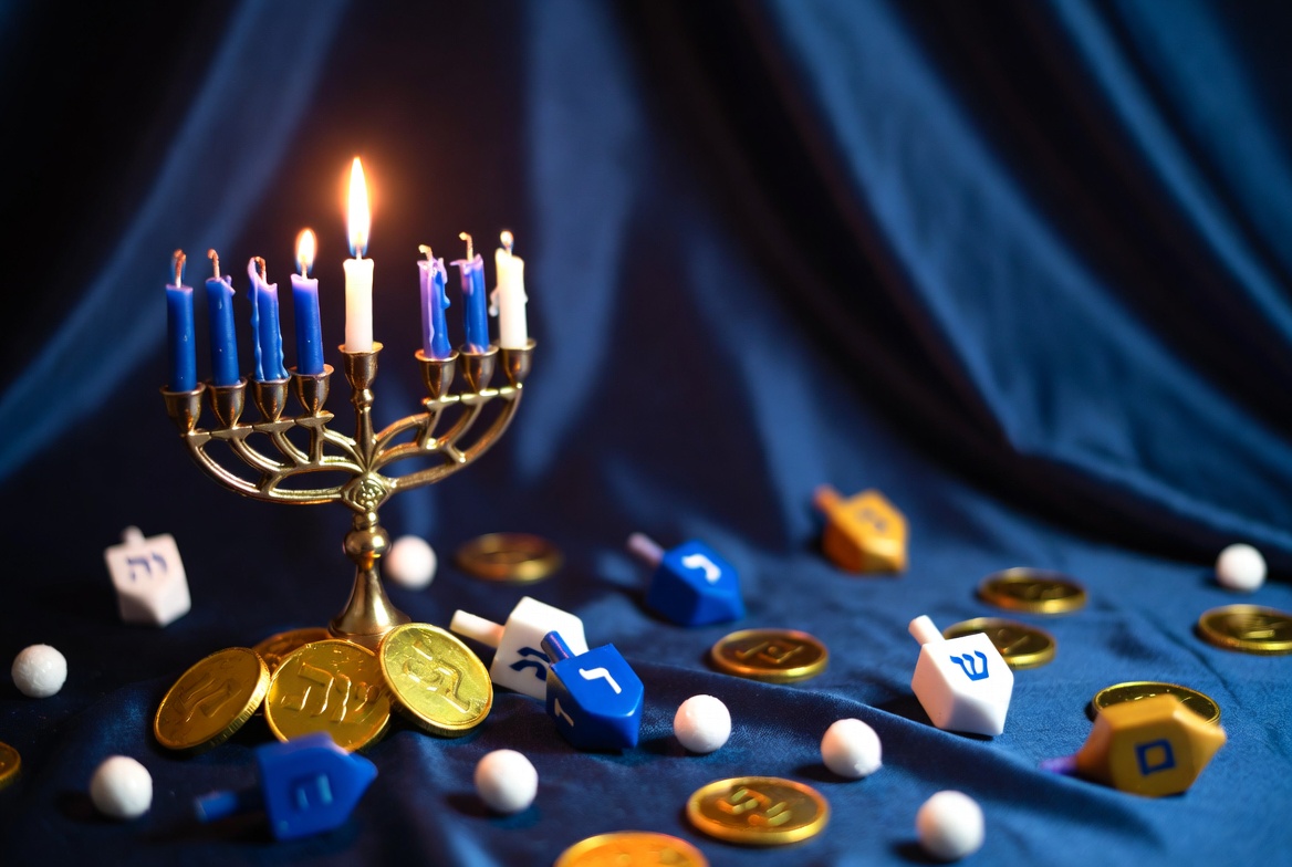 Lit Hanukkah Menorah with Dreidels and Coins Lit Hanukkah Menorah with Dreidels and Coins