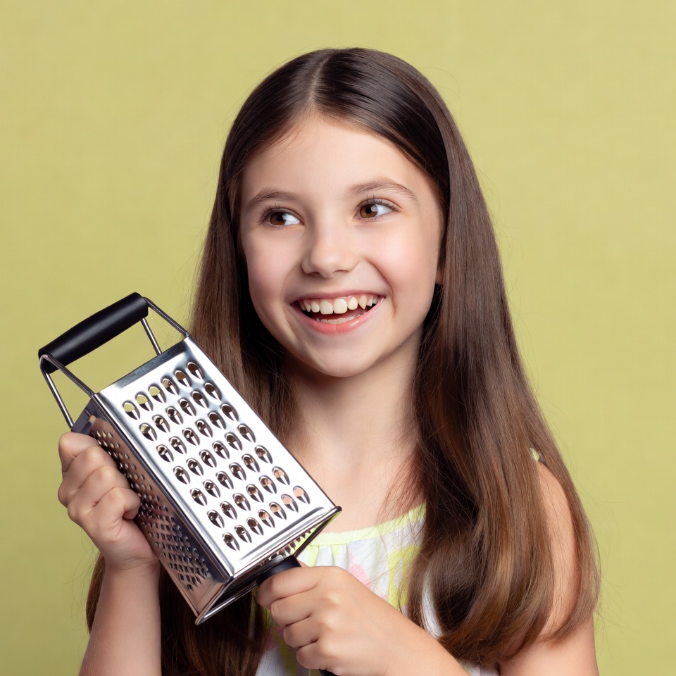 Girl holding cheese grater Girl holding cheese grater