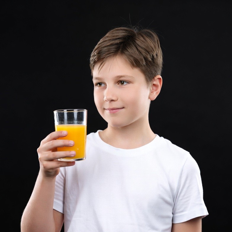 Boy holding glass of orange juice Boy holding glass of orange juice