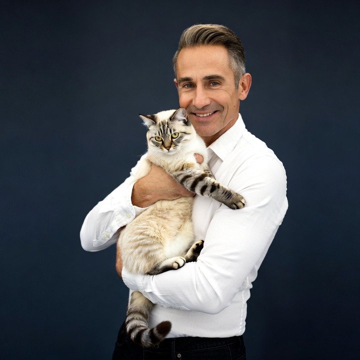 Man holding white cat Man holding white cat