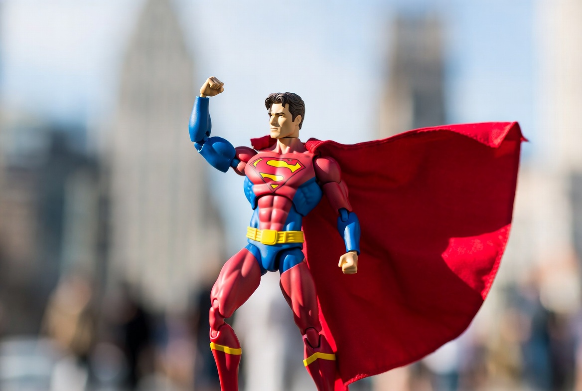 Superman action figure posing in city Superman action figure posing in city