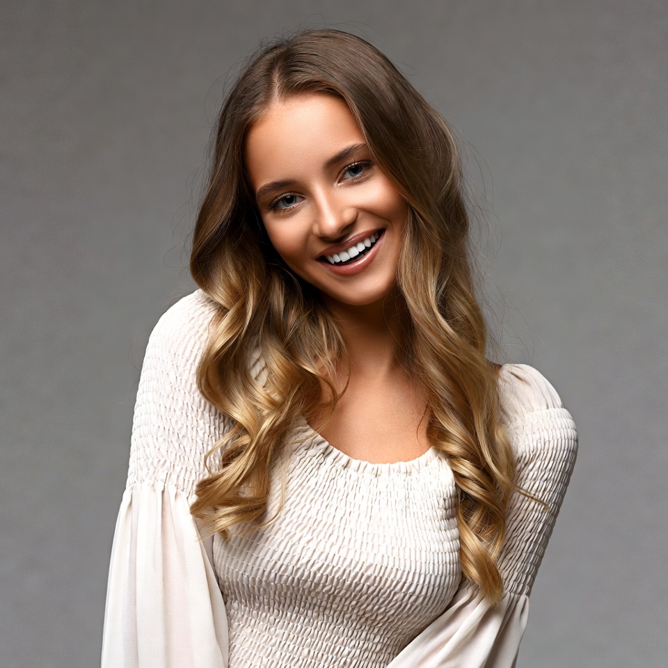 Smiling woman with wavy brown hair Smiling woman with wavy brown hair