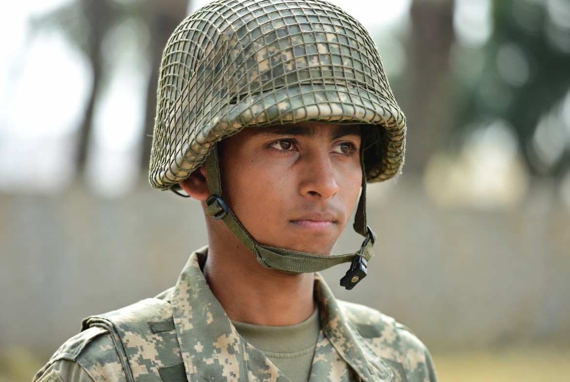 Soldier wearing camouflage helmet Soldier wearing camouflage helmet