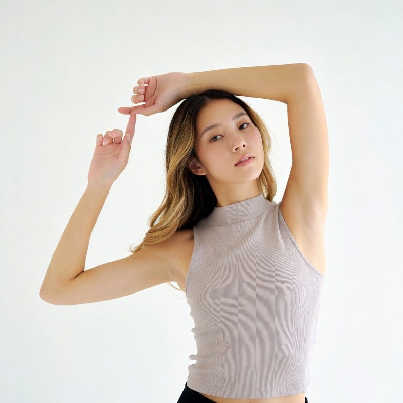 Asian woman posing with arms raised Asian woman posing with arms raised