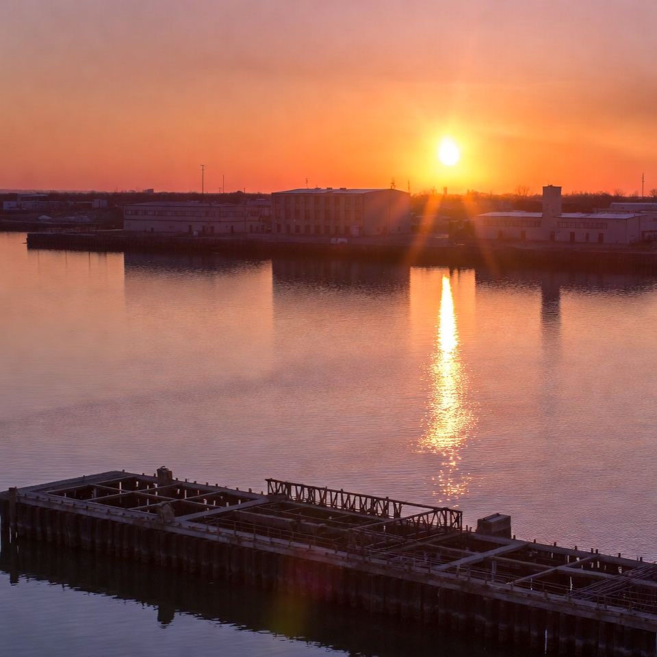 Sunset over industrial harbor docks Sunset over industrial harbor docks