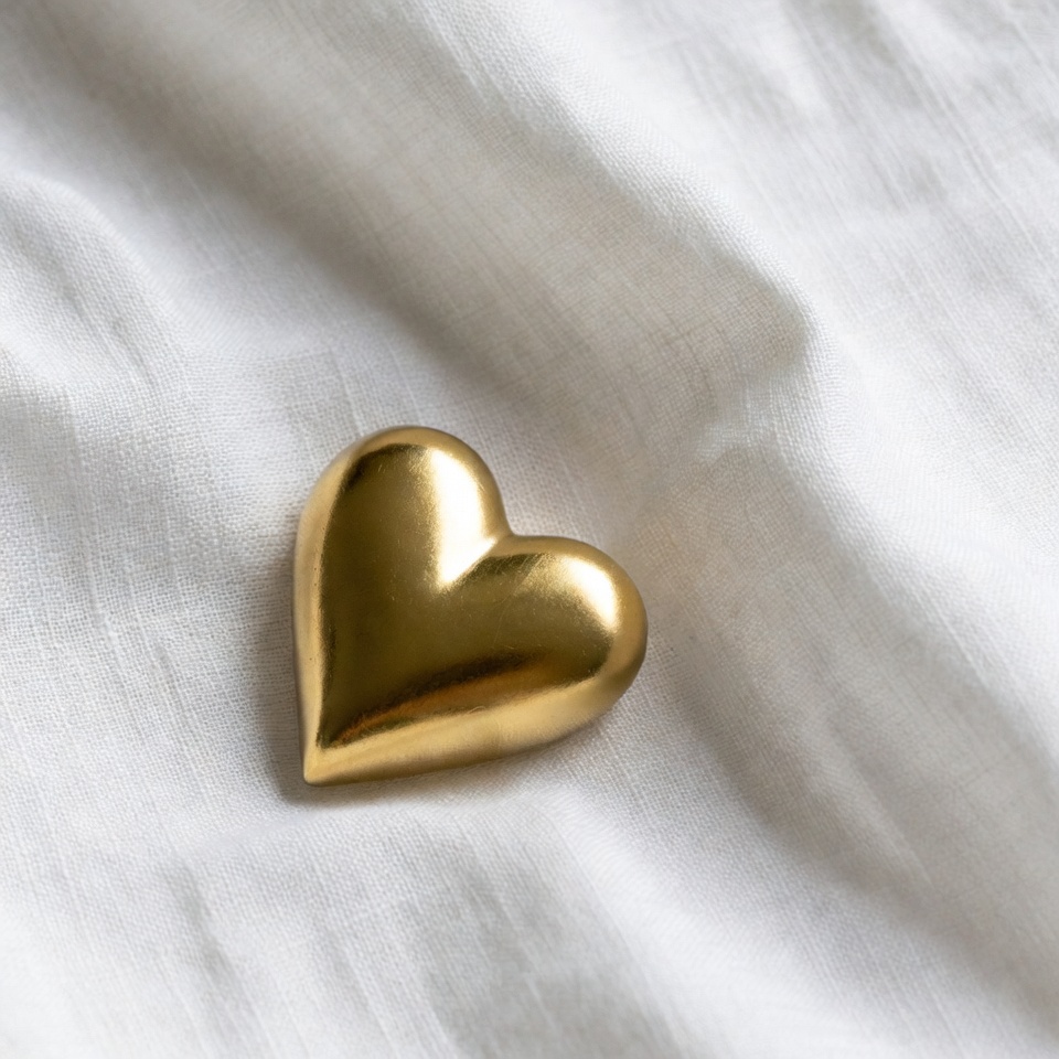 Gold heart on white fabric Gold heart on white fabric