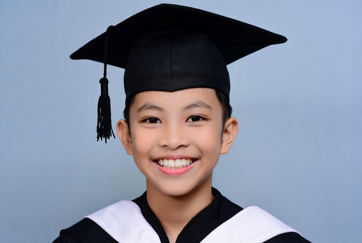 Asian boy in graduation cap and gown Asian boy in graduation cap and gown