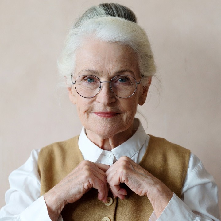 Elderly woman adjusting vest collar Elderly woman adjusting vest collar