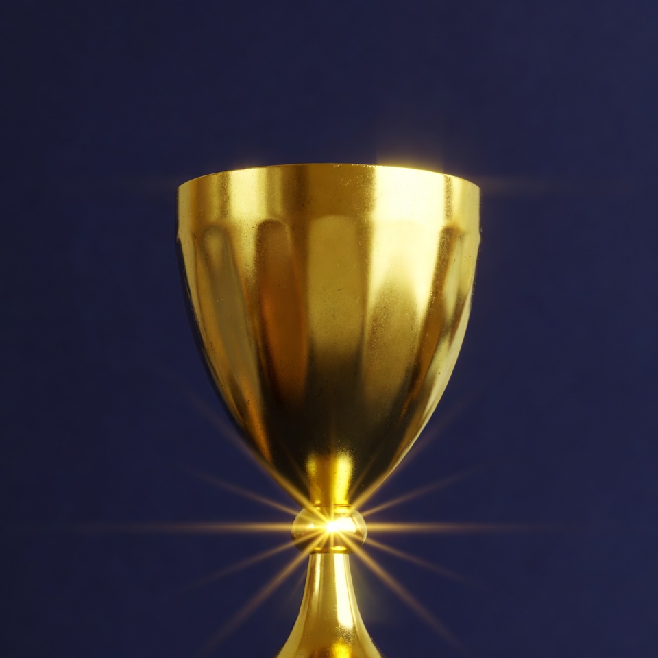 Shiny Golden Trophy on Blue Background Shiny Golden Trophy on Blue Background