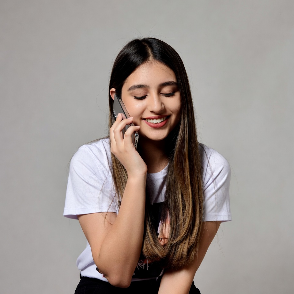 Young woman smiling on phone call Young woman smiling on phone call