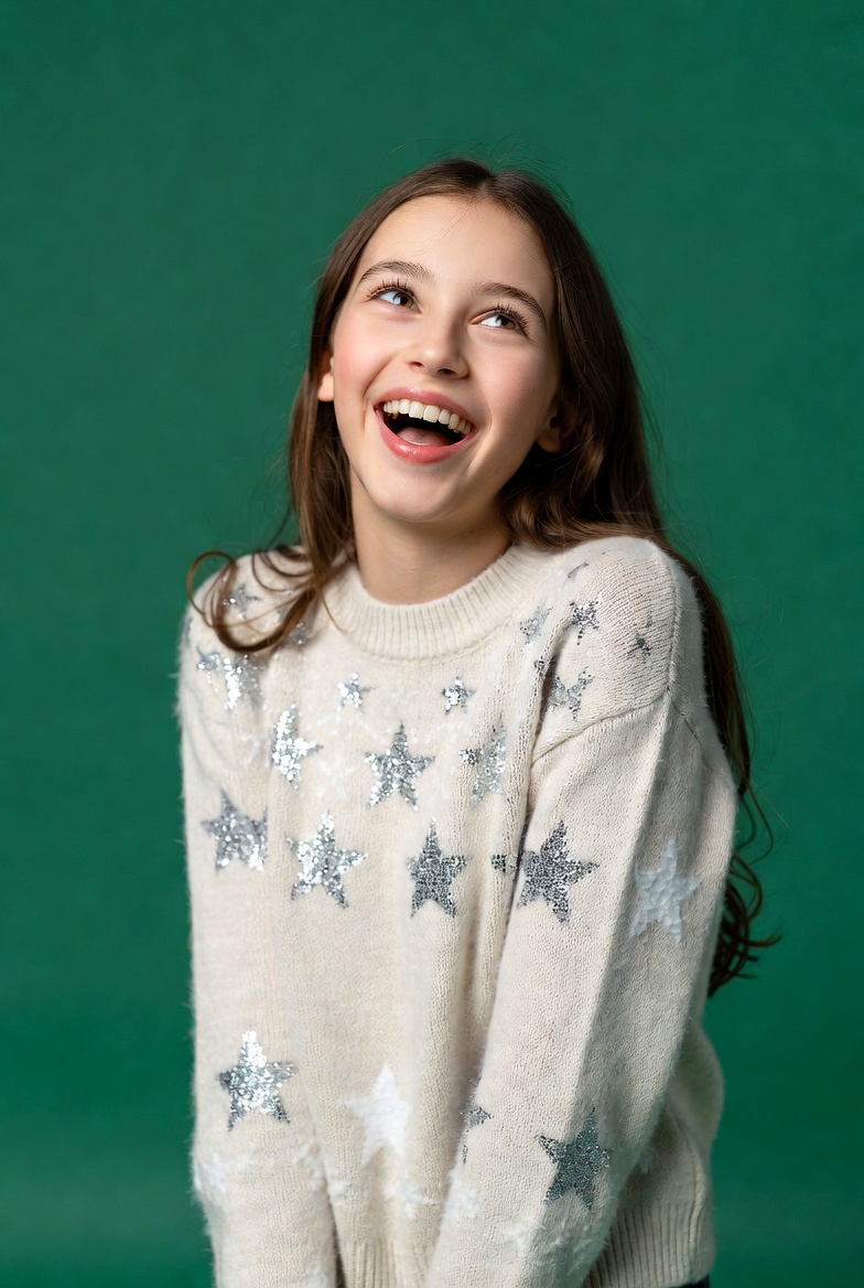 Girl smiling in sparkly star sweater Girl smiling in sparkly star sweater