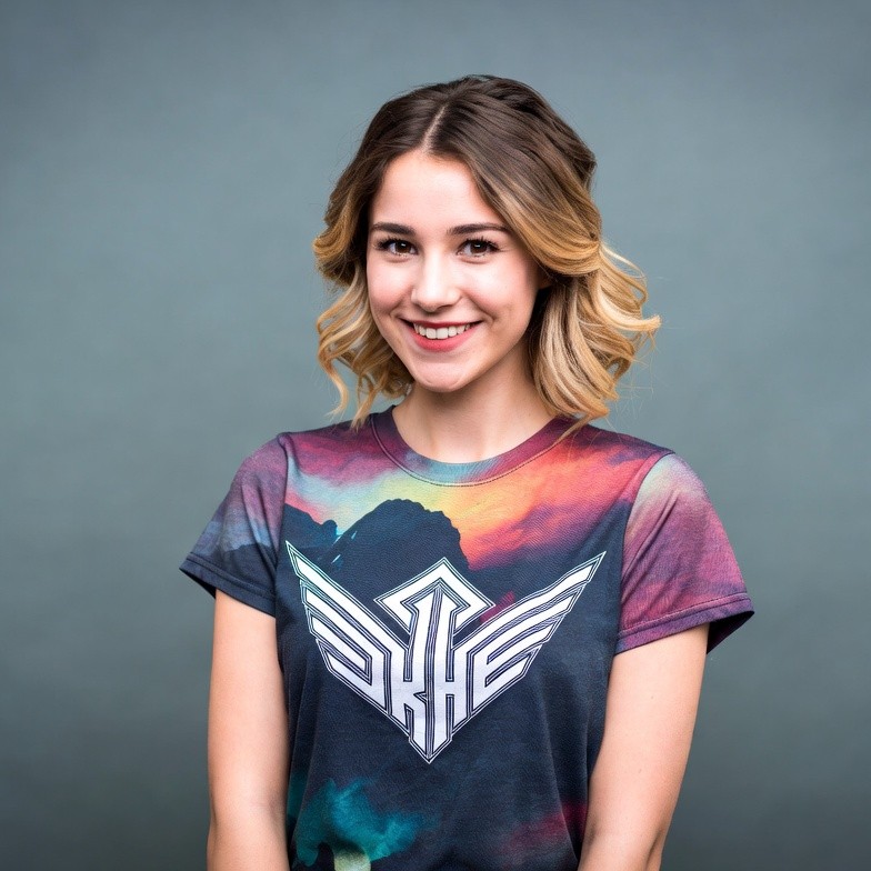 Smiling woman in colorful SKHE t-shirt Smiling woman in colorful SKHE t-shirt