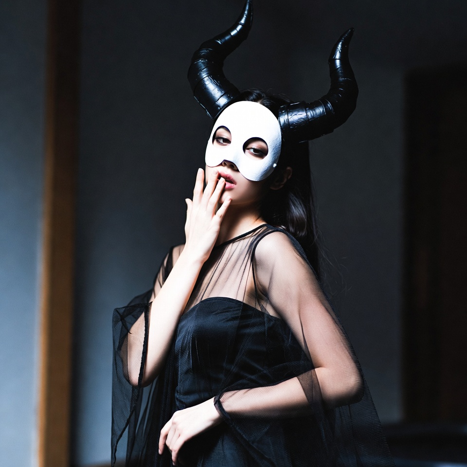 Asian woman in demon mask Asian woman in demon mask