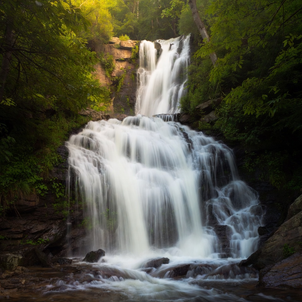 Waterfall cascading in lush green forest Waterfall cascading in lush green forest