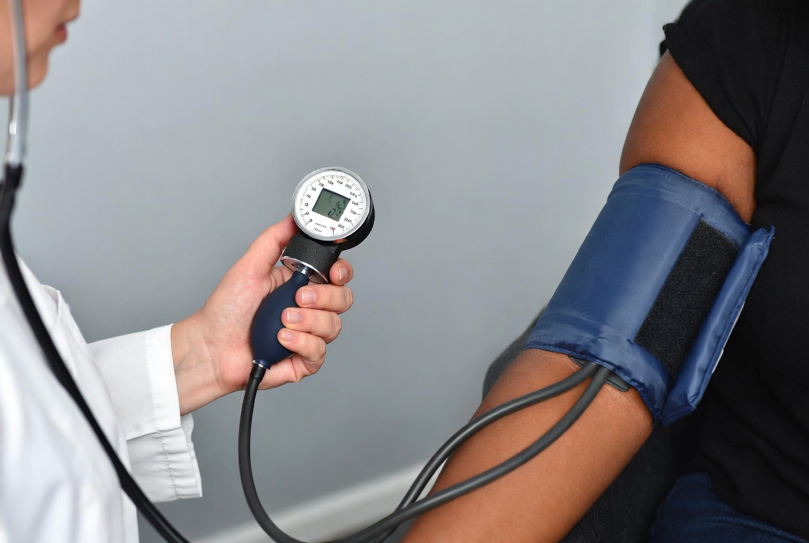 Doctor measuring woman's blood pressure Doctor measuring woman's blood pressure